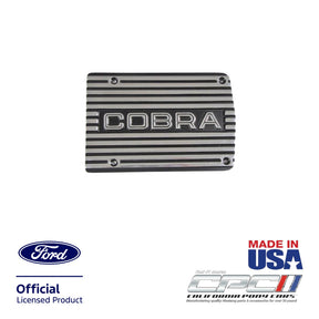 Front view of polished A/C compressor cover plate with Cobra lettering for Ford engines, Ford Official Licensed Product, Made in the USA, CPC part ENG-000-483.
