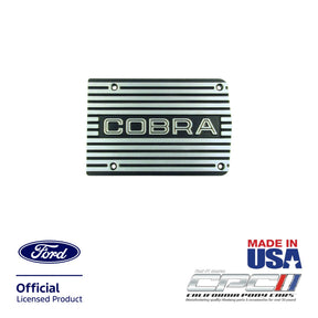 Front view of finned matte-finish Cobra A/C compressor cover plate with open COBRA lettering design for Ford small block engine applications, CPC part ENG-000-514.