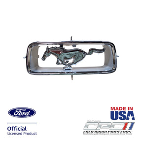 Front view of 1967 Ford Mustang horse and corral grille ornament assembly with chrome running horse and mounting tabs, CPC part EXT-067-402.